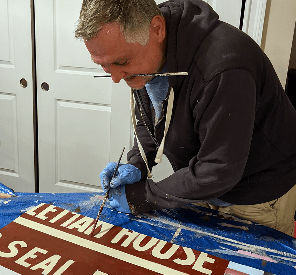 Artist painting a panel for a mural | Dubus Art Studio